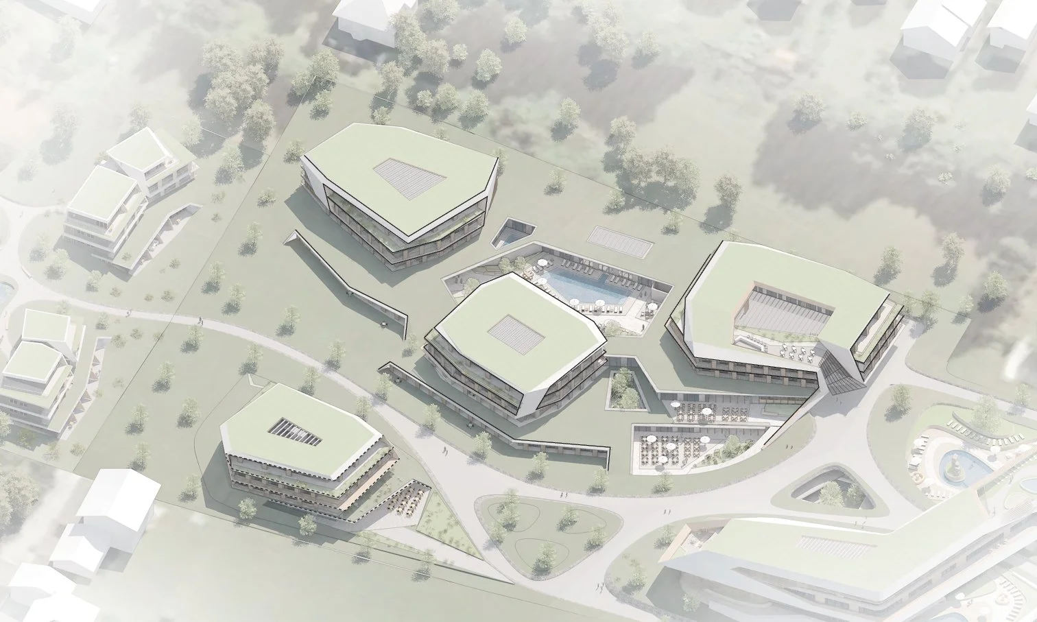 Aerial view of a modern residential or hotel complex with green roofs, surrounded by gardens, walking paths, a pool, and a plaza area, set in a suburban environment with a parking lot nearby.